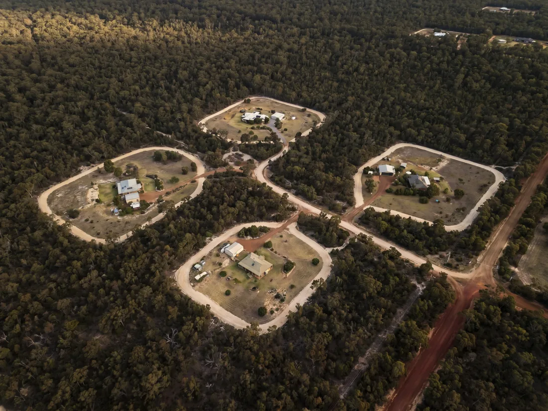 Aerial view of four rural-residential properties in the WA Hills, each ringed by a cleared firebreak perimeter against surrounding eucalypt bushland